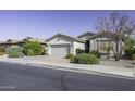 Single-story residence featuring a two-car garage complemented by drought-resistant landscaping at 2512 E Katrina Trl, Casa Grande, AZ 85194