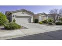 Inviting single-story house with a two-car garage and well-maintained front yard landscaping at 2512 E Katrina Trl, Casa Grande, AZ 85194