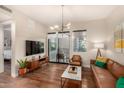 Open living room with stylish decor, hardwood floors, and access to a private balcony at 3131 N Central Ave # 3004, Phoenix, AZ 85012