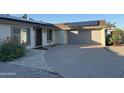 Single-story home featuring a driveway, two-car garage, desert landscaping, and solar panels at 3734 W Dailey St, Phoenix, AZ 85053
