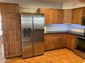 Well lit kitchen featuring ample cabinet space, stainless steel refrigerator, and tile flooring at 3734 W Dailey St, Phoenix, AZ 85053
