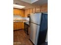 Kitchen with stainless steel appliances, wooden cabinets and laminate countertops at 3810 N Maryvale Pkwy # 2077, Phoenix, AZ 85031