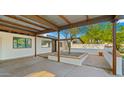 View from inside the carport, showing the entrance, desert landscaping, and pebble accents at 4040 E Becker Ln, Phoenix, AZ 85028