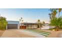 Beautiful desert home with a long driveway, carport, and unique desert landscaping at 4040 E Becker Ln, Phoenix, AZ 85028