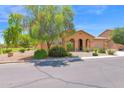 Attractive single-story house featuring desert landscaping, an arched entrance, and a side fence at 40479 W Marion May Ln, Maricopa, AZ 85138