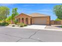 Charming single-story home featuring a tile roof, desert landscaping, and a two-car garage at 40479 W Marion May Ln, Maricopa, AZ 85138