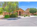 Inviting single-story home with a tile roof, desert landscaping, and an arched entryway at 40479 W Marion May Ln, Maricopa, AZ 85138