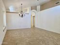 Spacious living room with natural light, featuring tile flooring, neutral walls, and a hanging chandelier at 4224 E Renee Dr, Phoenix, AZ 85050