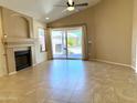 Inviting living room featuring a cozy fireplace, tile flooring, and a sliding glass door leading to the backyard at 4224 E Renee Dr, Phoenix, AZ 85050