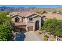 Charming two-story home featuring a tile roof, three-car garage, and landscaped front yard with mountain views at 4264 S Columbine Way, Gold Canyon, AZ 85118