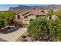 Charming two-story home featuring a tile roof, three-car garage, and landscaped front yard with mountain views at 4264 S Columbine Way, Gold Canyon, AZ 85118