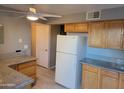 Bright kitchen with light wood cabinets, white appliances and stone-look countertops, with an open design at 4615 N 39Th Ave # 21, Phoenix, AZ 85019