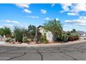 Corner lot featuring desert landscaping, mature trees, and charming curb appeal at 481 S San Marcos Dr, Apache Junction, AZ 85120