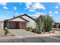Charming single-story home featuring desert landscaping, a covered carport, and a welcoming facade at 481 S San Marcos Dr, Apache Junction, AZ 85120