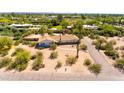 Expansive home featuring desert landscaping, complemented by a private yard and circular drive at 6009 N Kachina Ln, Paradise Valley, AZ 85253