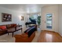 Spacious living room with natural light, plush furniture, and a beautiful grand piano at 6707 E Beverly Ln, Scottsdale, AZ 85254