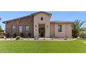 Beautiful home with a stone facade, manicured lawn, and an inviting entrance at 6917 E Ingram Cir, Mesa, AZ 85207