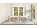 Dining area featuring natural lighting and a modern table with seating for six at 7327 S 76Th Ln, Laveen, AZ 85339