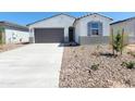 Welcoming single-story home with a two-car garage and desert landscaping at 8576 W Yorktown Ct, Florence, AZ 85132