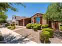 Charming single-story brick home with manicured landscaping and a two-car garage at 10618 E Kinetic Dr, Mesa, AZ 85212