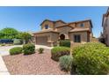 Charming desert home featuring low-maintenance landscaping, a spacious driveway, and an attached two-car garage at 10910 E Sebring Ave, Mesa, AZ 85212