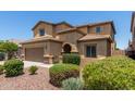 Charming desert home featuring low-maintenance landscaping, a spacious driveway, and an attached two-car garage at 10910 E Sebring Ave, Mesa, AZ 85212