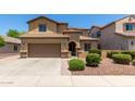 Inviting two-story home boasts a desert-landscaped front yard and a convenient two-car garage at 10910 E Sebring Ave, Mesa, AZ 85212
