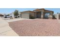 Inviting single-story home with a two-car garage and desert landscaping at 11548 W Cottonwood Ln, Avondale, AZ 85392