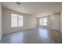 Bright living room with wood-look floors, neutral paint, and lots of natural light at 11548 W Cottonwood Ln, Avondale, AZ 85392
