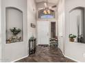 Inviting foyer with decorative shelving and tiled floor at 12325 W Berridge Ln, Litchfield Park, AZ 85340