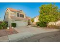 Charming two-story home boasts a tile roof, a spacious two-car garage and a well-maintained landscaped yard at 1405 N Jamaica Way, Gilbert, AZ 85234