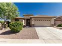 Charming single-story home featuring a two-car garage, well-maintained landscaping, and a welcoming entrance at 15429 W Ventura St, Surprise, AZ 85379