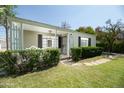 Inviting front porch featuring a quaint bench and secure gate entrance at 1609 W Lewis Ave, Phoenix, AZ 85007