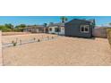 Wide view of a gravel front yard and charming home with neutral colors and tasteful landscaping at 1621 W Mulberry Dr, Phoenix, AZ 85015