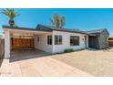 Exterior of a well-maintained home with a carport and drought-friendly gravel landscaping at 1621 W Mulberry Dr, Phoenix, AZ 85015