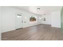 Bright, freshly-painted living room featuring hardwood floors and abundant natural light at 1621 W Mulberry Dr, Phoenix, AZ 85015