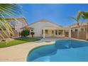 Inviting backyard featuring a private pool, artificial turf, and a covered patio, perfect for outdoor entertaining at 17649 N Vera Cruz Ave, Maricopa, AZ 85139