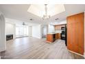 Open-concept living area with hardwood floors, a fireplace, and a modern kitchen at 1820 E Morten Ave # 119, Phoenix, AZ 85020