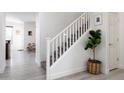 Bright staircase features white railing and a decorative potted plant at 18809 E Seagull Dr, Queen Creek, AZ 85142