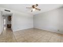 Cozy bedroom featuring tile flooring, a ceiling fan, and a doorway leading to another room for added convenience at 2064 S Farnsworth Dr # 43, Mesa, AZ 85209
