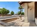 Inviting front porch with a brick accent wall and decorative light fixture, perfect for enjoying the neighborhood view at 2064 S Farnsworth Dr # 43, Mesa, AZ 85209