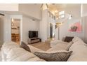A cozy living room boasts an L-shaped sectional sofa, wood floors, and access to a dining area at 2117 E Saltsage Dr, Phoenix, AZ 85048
