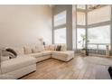This light-filled living room is large with high ceilings and a comfortable sectional sofa at 2117 E Saltsage Dr, Phoenix, AZ 85048
