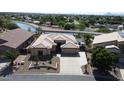 Aerial view showcasing a well-maintained home with a desert landscape, tile roof, and backyard canal at 2122 N Stapley Dr, Mesa, AZ 85203