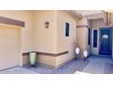Inviting front porch showcasing decorative pots, brick pavers, and a stylish glass-paneled front door at 2122 N Stapley Dr, Mesa, AZ 85203