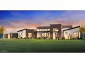 Stunning modern home with a manicured lawn and a dramatic sunset backdrop at 21963 E Sunset Dr, Queen Creek, AZ 85142