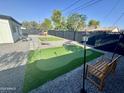 Spacious backyard with synthetic grass, a putting green, and outdoor games for entertaining at 2509 E Meadowbrook Ave, Phoenix, AZ 85016