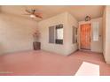 Enclosed patio with neutral walls, terracotta tile, and a wooden front door at 2699 E Claxton Rd, Gilbert, AZ 85297