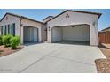 Single story home showcasing an open garage with ample parking space and well-maintained xeriscaping at 31570 N 123Rd Ln, Peoria, AZ 85383