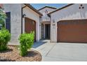 Elegant single-story home featuring a tandem three car garage, desert landscaping, and a welcoming entrance at 31570 N 123Rd Ln, Peoria, AZ 85383